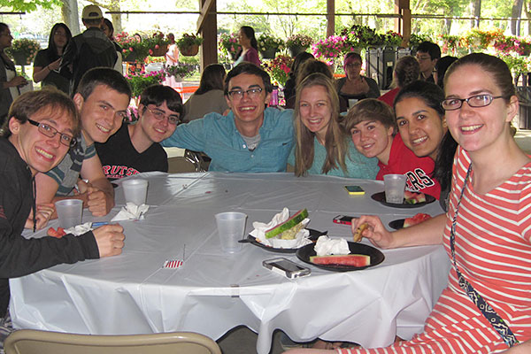 Eight students gathered around a table.